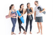 © ultramansk - Group of happy sporty women and guy wearing body stylish sportswear holding personal carpets leaned on a white background. waiting for yoga class or body weight class. healthy lifestyle and wellness