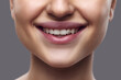 © Lustre Art Group  - Beautiful smiling female mouth. Close-up of person's lower face featuring well-defined, plump lips with subtle natural gloss. Concept of dental health, importance of healthy smile and lips. Ad