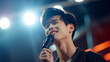 © S photographer - Young Asian man singing at a concert.