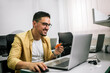 © Mediteraneo - Happy cheerful smiling young adult man doing online shopping or e-shopping