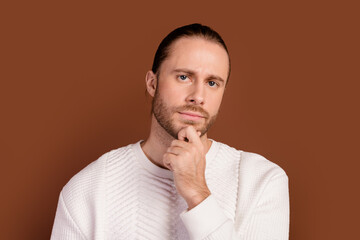 Sticker - Photo of uncertain serious guy dressed white pullover arm chin thinking isolated brown color background