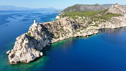 Wall Mural - Aerial drone video of beautiful and picturesque cape Melagavi forming a small peninsula with unique lighthouse stand out next to archaeological site of Heraion, Loutraki, Greece