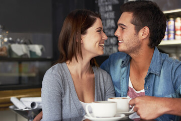 Canvas Print - Smile, shop and couple drinking coffee in cafe, care and bonding together on valentines day date. Happy, man and woman in restaurant with latte for love connection, conversation and relationship