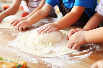 Three children kneading cookie dough on kitchen counter