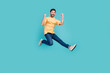 © deagreez - Full length photo of sportive ambitious sports man jumping raised fists up leader in competition isolated on aquamarine color background