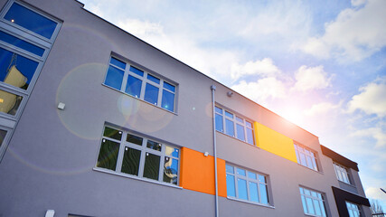 Wall Mural - Multi-colored facades of the school with white window frames.