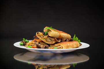 Wall Mural - fried thin pancakes stuffed with meat and mushrooms.