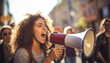 An earnest woman shouting through a megaphone at a protest march evoking a sense of empowerment