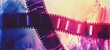 A reel of vintage film illuminated by colorful lights, capturing the essence of classic cinematography - a nostalgic visual journey
