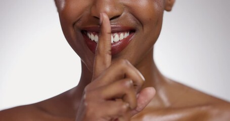 Wall Mural - Black woman, hand and lips in secret for skincare, cosmetics or beauty on a gray studio background. Closeup of African female person with smile and finger on mouth for gossip, whisper or silence