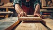 © pinkrabbit - man owner a small furniture business is preparing wood for production. carpenter male is adjust wood to the desired size. architect, designer, Built-in, professional wood, craftsman, workshop..