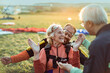 © Marko Geber - Happy senior woman landing with skydiving instructor