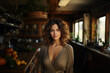 © Helios4Eos - Beautiful modern woman standing in a kitchen with wooden accents.