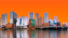 Boston City Skyline, Skyscrapers And Water Reflections On The Charles River With The Orange-color Sky Backgrounds In Massachusetts, USA