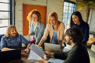 Wall Mural - Multicultural team working together in modern office space