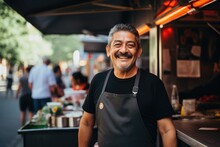 Smiling Portrait Of A Middle Aged Mexican Man Working In Food Truck
