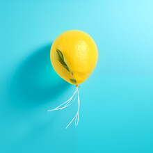 Lemon Floats In The Air, On A Turquoise Background, Looks Like A Balloon, Is Tied Like A Balloon, Original Summer Funny Concept