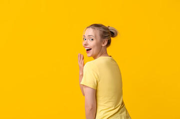 Poster - Beautiful happy young woman laughing on yellow background