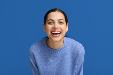 Sticker - Beautiful young happy woman laughing on blue background