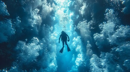 Diver with diving suit, diving in a coral reef with many jellyfish and fish