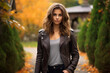 A stylish woman in a brown leather bomber jacket enjoying a peaceful autumn afternoon in a rustic countryside setting, with vibrant fall foliage in the background