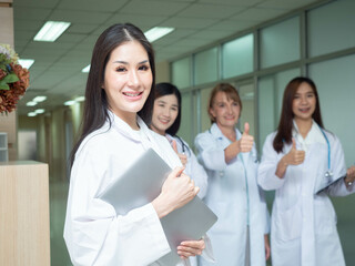 Female woman lady girl white skin wear uniform hospital clinic laboratory look at camera holding report document information paper tablet smartphone mobile thumb up happy smile servie health care work