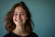 © MagnusCort - A young woman is smiling with her hair blowing in the wind