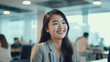© GulArt - Closeup portrait of an Asian business woman in suit standing in the office room