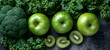 Green vegetables and fruits on a black background