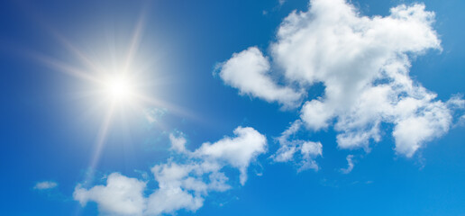 Wall Mural - bright sun on beautiful blue sky with white clouds.
