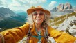 © MiguelAngel - Happy older woman hiking and takes a photo selfie with the phone.