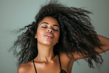 Wall Mural - black woman with long curly hair blowing