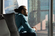 © fizkes - Creating idea. Pensive biracial businessman sit in cozy ergonomic armchair by window of corporate office look at distance. Young black guy team leader think on business vision strategy plan. Copyspace