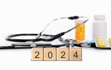 Wall Mural - Happy 2024 New Year medical concept. Set of Wooden block