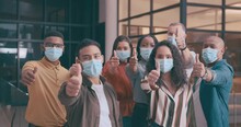 Business People, Face Mask And Thumbs Up For Success, Good Job Or Teamwork Together At Office. Group Of Employees In Diversity With Like Emoji, Yes Sign Or OK In Approval For Agreement At Workplace