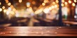 © Sona - Blurred restaurant lights background with wooden table in front.