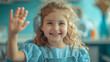 little cute girl in dental clinic waving to camera
