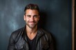 © Inigo - Portrait of a handsome young man wearing a leather jacket and smiling