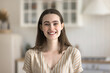 © fizkes - Head shot of happy beautiful young slim woman standing alone in modern domestic kitchen smile looking at camera, posing indoor, having charming toothy smile, advertise dental services. Tenant portrait