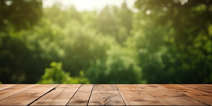 ideal for photo editing or showcasing products, an empty wooden table with a blurred green forest ba