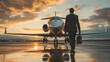 a man walking towards a private jet airplane preparing to board