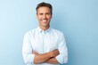 © Iigo - portrait of handsome middle aged man with arms crossed over blue background