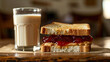 perfect plated shot of a peanut butter and jelly sandwich with full glass of milk beside it 