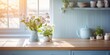 © Sona - Scandinavian-style kitchen with wooden blue table and flower pot in morning light.