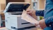 Businessman print paper on a multifunction laser printer in business office.