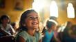 © tashechka - A little girl in a classroom, smiling brightly as sunlight streams in through the window.