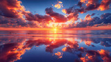 Fototapeta  - A breathtaking view of a vivid sunset with reflected clouds on damp sand during low tide Background