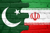Fototapeta Natura - Flags of Pakistan and Iran painted on a brick wall