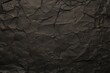 Black recycled paper crumpled texture background.