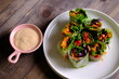 Spring rolls are a rolled appetizer or dim sum commonly found in Chinese and Asian cuisine. Raw fresh vegetable salad roll with mayonnaise.